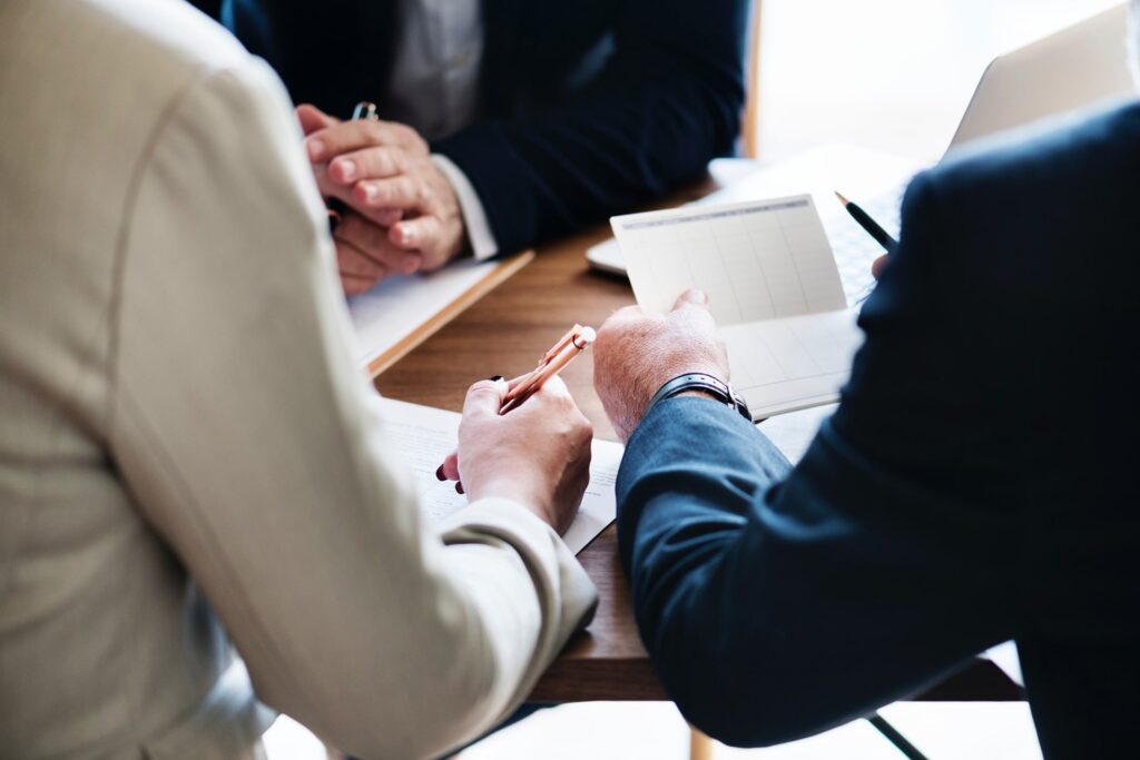 A group of law professionals discussing family law matters in a meeting room.